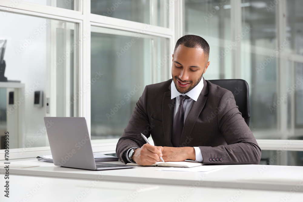 Happy man working at table in office. Lawyer, businessman, accountant or manager Happy man working at table in office. Lawyer, businessman, accountant or manager