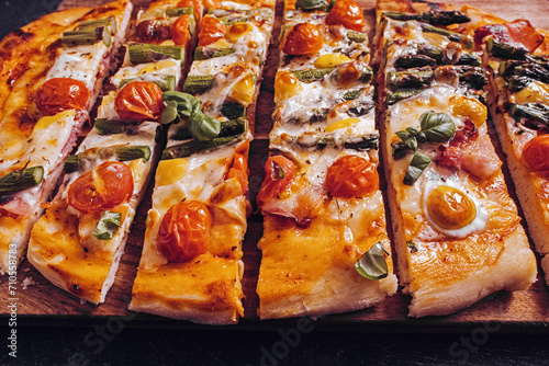 Sliced asparagus and prosciutto pizza with mozzarella closeup