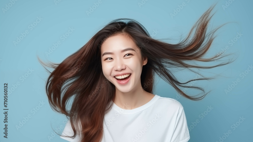 Fototapeta premium Happy Asian woman on blue background.