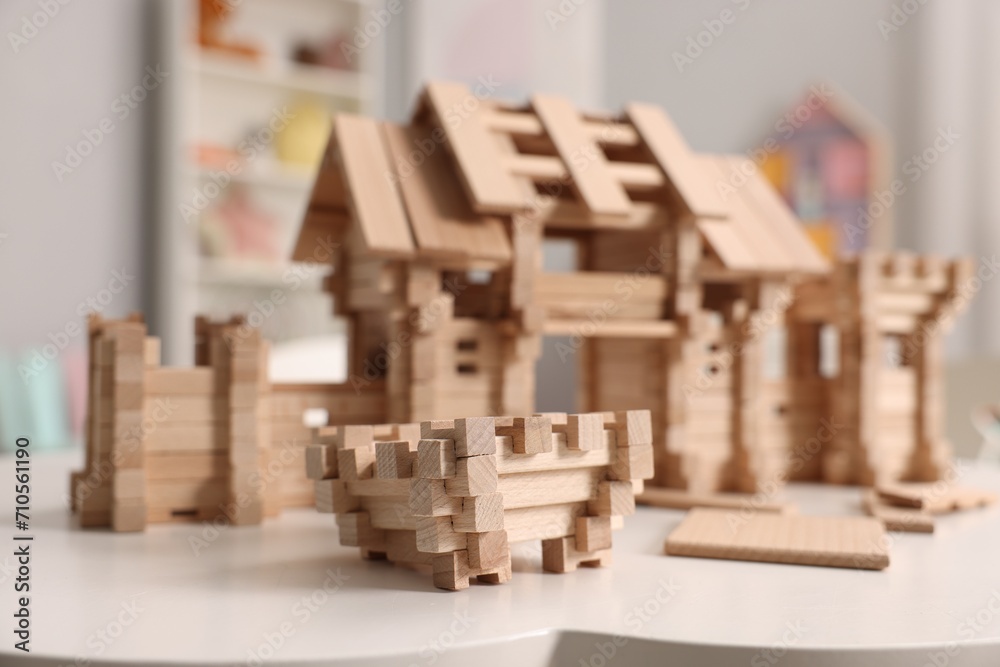 Wooden entry gate and building blocks on white table indoors, selective focus. Children's toy Wooden entry gate and building blocks on white table indoors, selective focus. Children's toy
