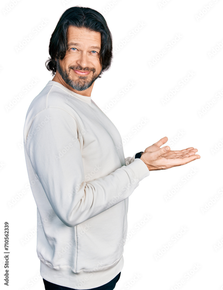 Middle age caucasian man wearing casual clothes pointing aside with hands open palms showing copy space, presenting advertisement smiling excited happy Middle age caucasian man wearing casual clothes pointing aside with hands open palms showing copy space, presenting advertisement smiling excited happy