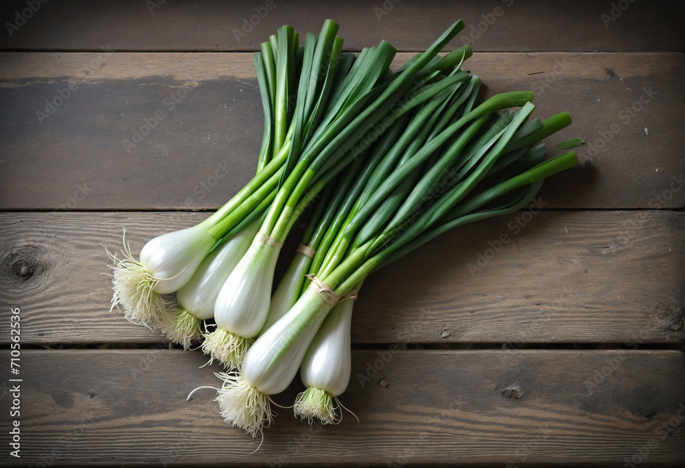 Freshly harvested scallions on weathered table with knife Freshly harvested scallions on weathered table with knife
