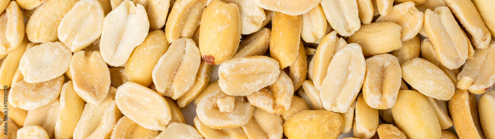 Heap of roasted peeled peanut grains, delicious groundnut banner background. Nuts texture close-up. Healthy natural snack. Heap of roasted peeled peanut grains, delicious groundnut banner background. Nuts texture close-up. Healthy natural snack.