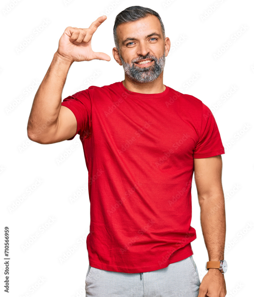Middle age handsome man wearing casual clothes smiling and confident gesturing with hand doing small size sign with fingers looking and the camera. measure concept.