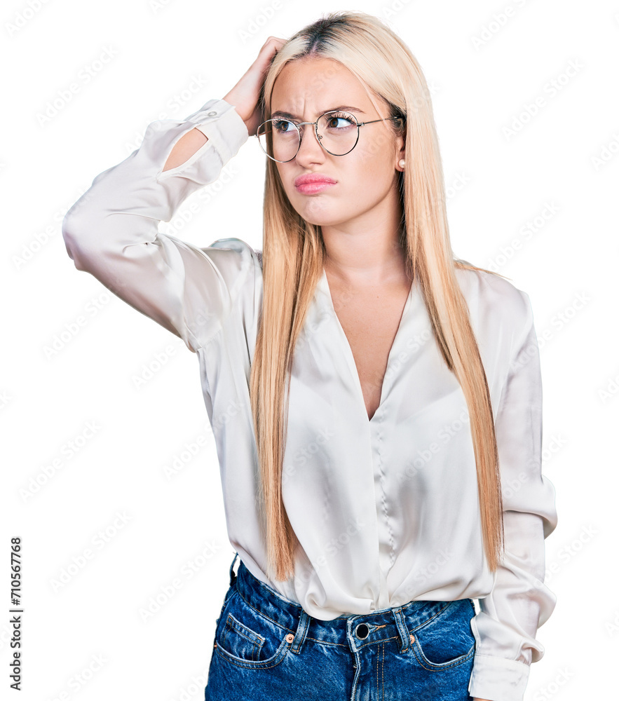Beautiful blonde woman wearing elegant shirt and glasses confuse and wondering about question. uncertain with doubt, thinking with hand on head. pensive concept.