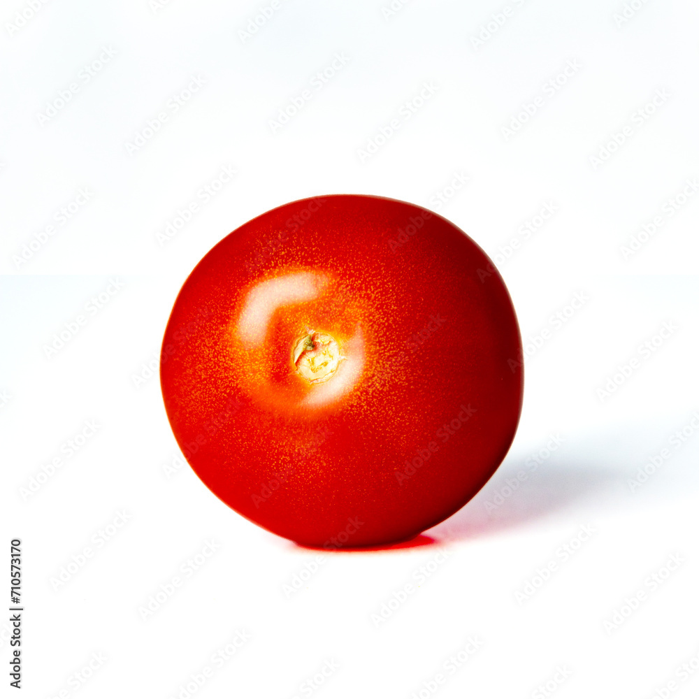 Vibrant red tomato against a clean white background Vibrant red tomato against a clean white background