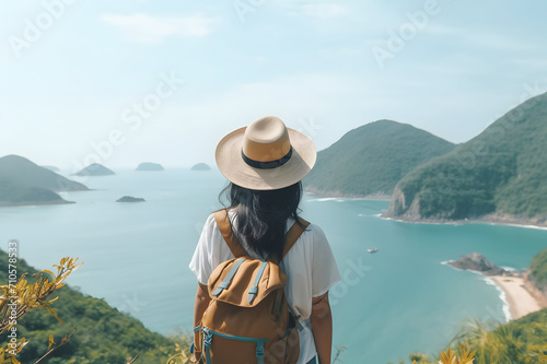 Back view of asian woman traveler with backpack and hat looking at beautiful seascape.