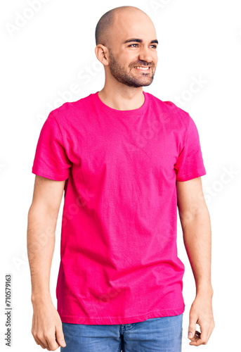 Wallpaper Mural Young handsome man wearing casual t shirt looking away to side with smile on face, natural expression. laughing confident. Torontodigital.ca