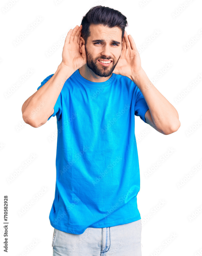 Young handsome man with beard wearing casual t-shirt trying to hear both hands on ear gesture, curious for gossip. hearing problem, deaf Young handsome man with beard wearing casual t-shirt trying to hear both hands on ear gesture, curious for gossip. hearing problem, deaf