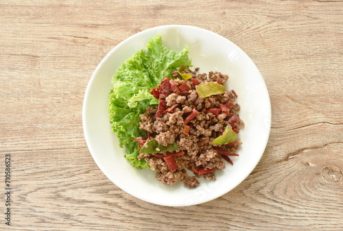 spicy fried chop beef meat couple dry chili with lettuce on plate