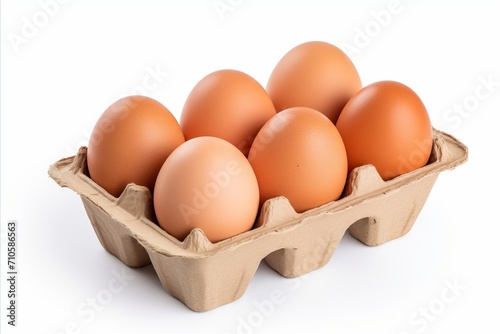 Organic farm fresh eggs neatly arranged in a cardboard box, isolated on a clean white background © Ilja