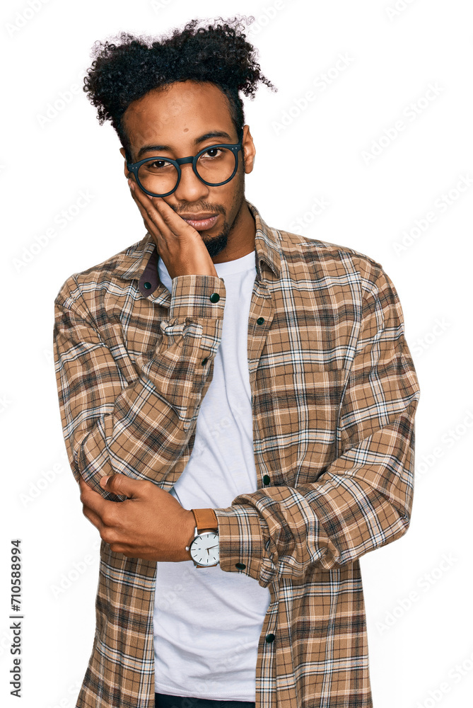 Young african american man with beard wearing casual clothes and glasses thinking looking tired and bored with depression problems with crossed arms. Young african american man with beard wearing casual clothes and glasses thinking looking tired and bored with depression problems with crossed arms.