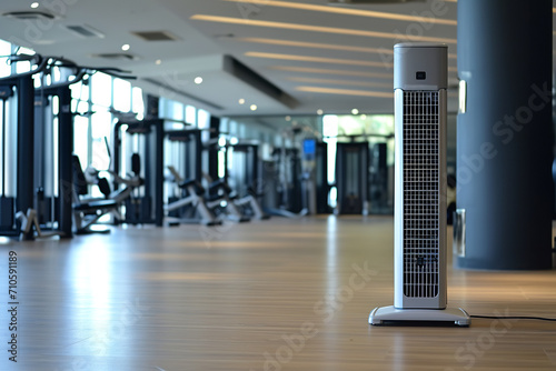 A high-speed tower fan in a modern gym, enhancing air quality and contributing to the sleek look of the fitness environment for optimal workout comfort