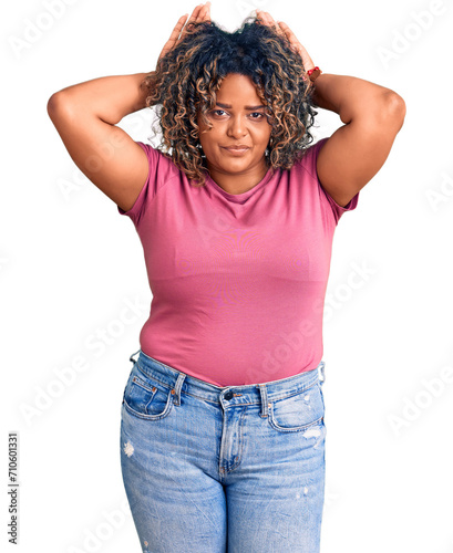 Young african american plus size woman wearing casual clothes doing bunny ears gesture with hands palms looking cynical and skeptical. easter rabbit concept. photo