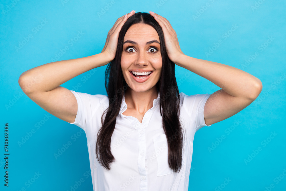 Photo of sweet impressed lady wear white shirt arms head big eyes isolated blue color background