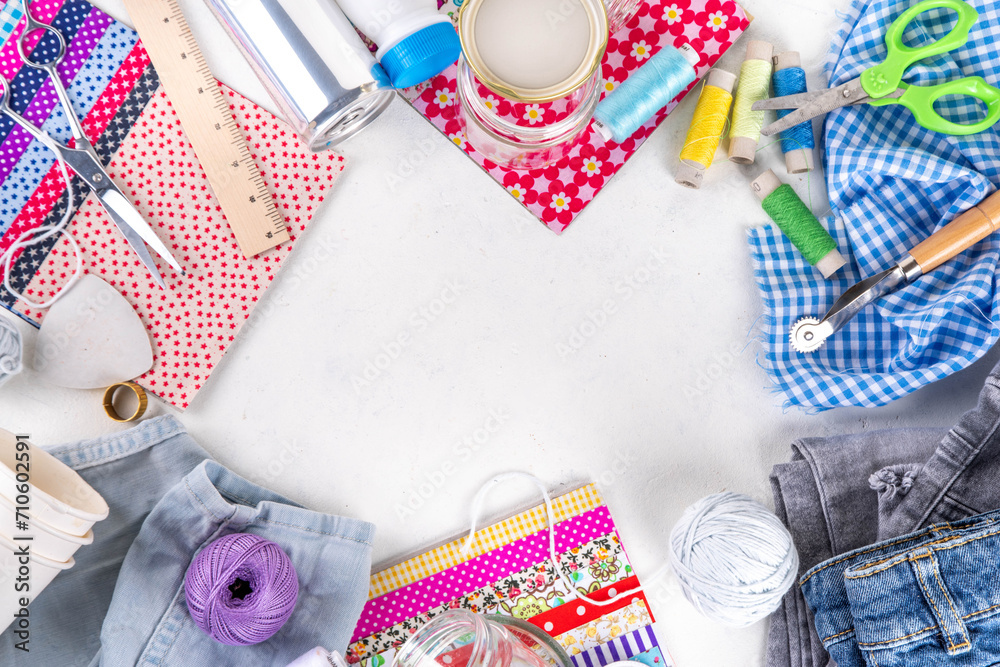 Fototapeta premium DIY upcycling ideas and materials background. Sustainable hobby with handmade, ecology creative reusable hand made with plastic bottles, metal cans, old jeans, fabrics, glass containers, top view