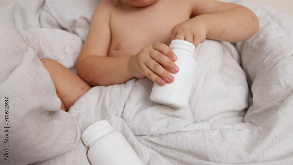 cute little baby boy playing with food supplement,vitamins or pills,capsules,sitting on bed. kid is counting pieces,putting in bottle.medicine in little toddler first.child is under supervision 4k cute little baby boy playing with food supplement,vitamins or pills,capsules,sitting on bed. kid is counting pieces,putting in bottle.medicine in little toddler first.child is under supervision 4k