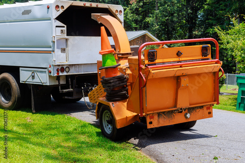 Chipped wood is released from wood chipper machine by grinding tree branches © ungvar