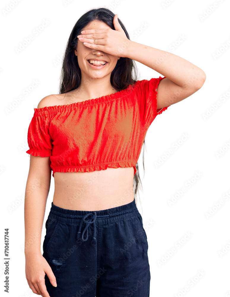 Fototapeta premium Brunette teenager girl wearing casual clothes smiling and laughing with hand on face covering eyes for surprise. blind concept.