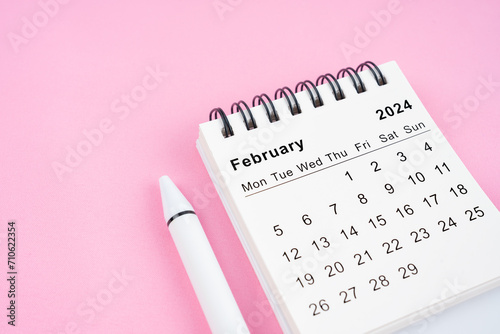 February 2024 month calendar on pink fabric background.