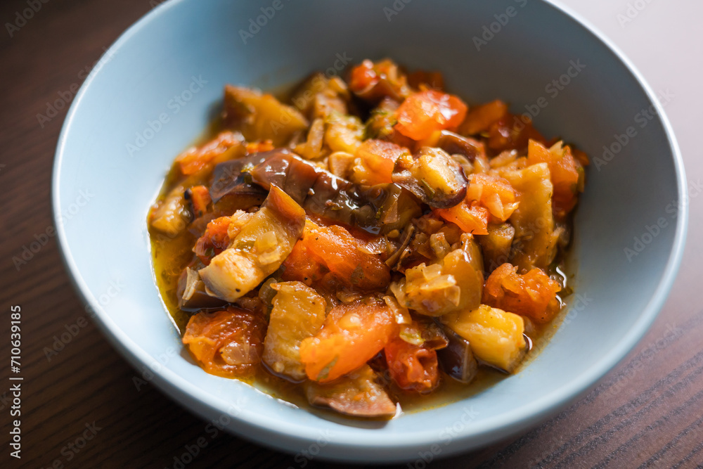 Soulful Comfort: Eggplant Stew in Blue Bowl Close-Up Soulful Comfort: Eggplant Stew in Blue Bowl Close-Up