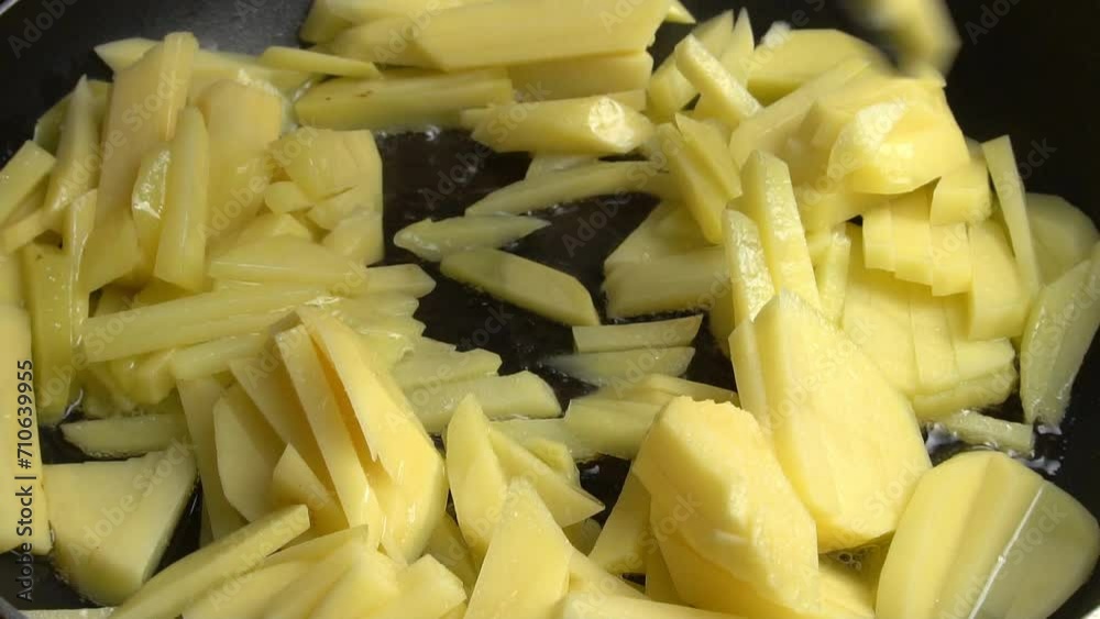 Cooking fried potatoes - stirring potatoes frying in a frying pan with sizzling oil. Culinary master class on home cooking. Video recipe. Cooking fried potatoes - stirring potatoes frying in a frying pan with sizzling oil. Culinary master class on home cooking. Video recipe.