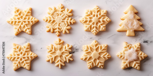 Top view Sugar Cookies Pre-Baking. Sugar cookies cut into form of stars and snowflakes, sprinkled with sugar, ready for baking.