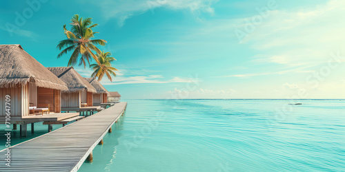 Tropical Resort Paradise with Overwater Bungalows, copy space for banner. Blue sky, luxury overwater bungalows with thatched roofs in a tropical island resort, serene blue ocean water.