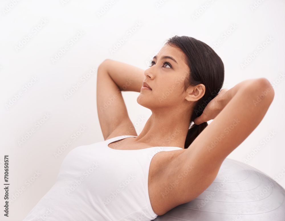 Fitness, exercise and girl with gym ball, commitment and energy for health, wellness and training. Workout, pilates and woman with equipment for balance, weight loss and body care on white background Fitness, exercise and girl with gym ball, commitment and energy for health, wellness and training. Workout, pilates and woman with equipment for balance, weight loss and body care on white background