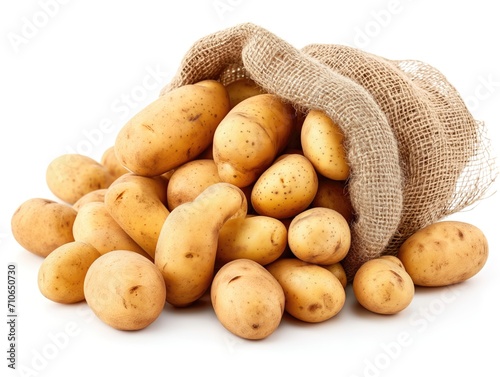 Fresh potatoes spilling out of a rustic burlap sack. The potatoes, with their smooth, lightly speckled skins, vary in size and are in natural, earthy tones.