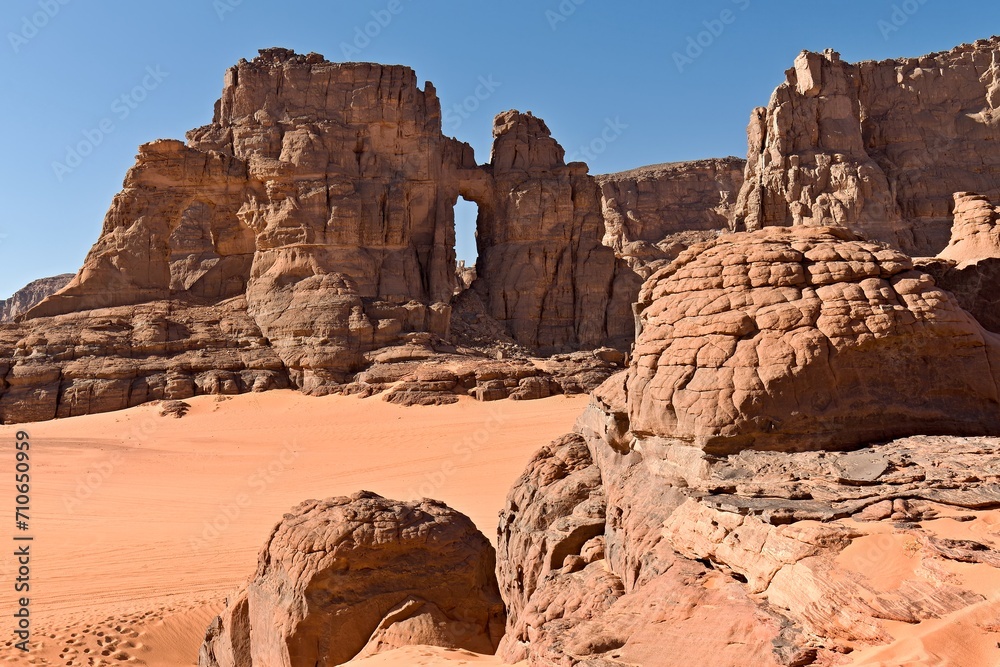Fototapeta premium View of Tamezguida cathedrale rock formation in Tadrart Rouge rocky mountain range in Tassili n Ajjer National Park. Sahara desert, Algeria, Africa.