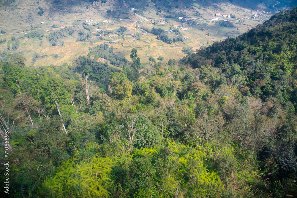 Aerial view lush green forest of Hoang Lien Son national park with Muong Hoa valley terraced paddy fields, low density houses in background, Sa Pa, Lao Cai, Vietnam travel destination