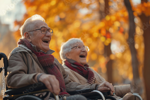 portrait of seniors in wheelchairs, laughing and talking happily