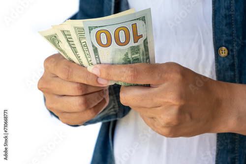 Woman's hands tightly hold 100 dollar bills