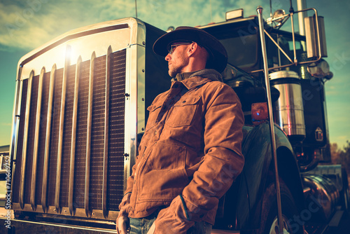 Semi Truck Cowboy Driver Enjoying Scenic Sunset Next to His Vehicle