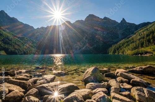Fototapeta Naklejka Na Ścianę i Meble -  Beautiful, colorful mountain lake with an azure surface and mountain peaks with beautiful sunlight. Morskie Oko - Eye of the Sea - Tatry - Tatra Mountains, Sun reflections