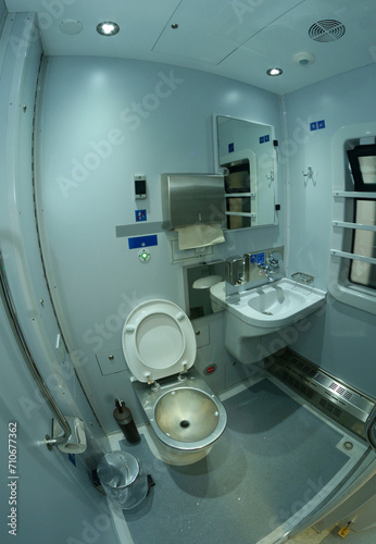 Toilet in Railways First Class sleeping carriage of a passenger train, toilet bowl, washbasin, mirrors and paper box