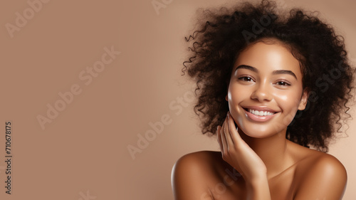 Afro woman with a healthy glowing skin is applying a skincare product.