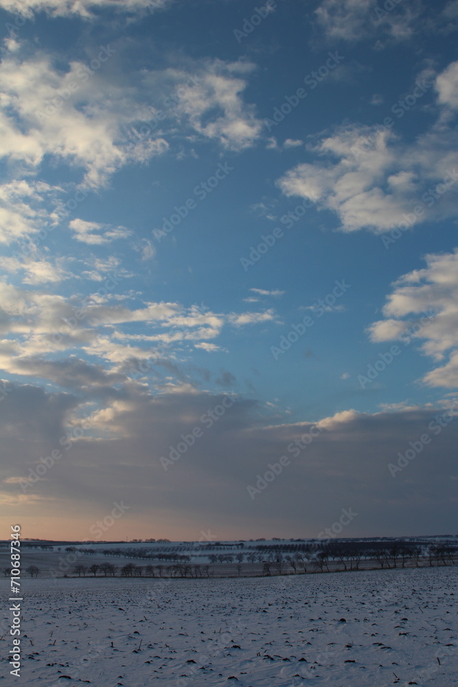 A snowy landscape with clouds