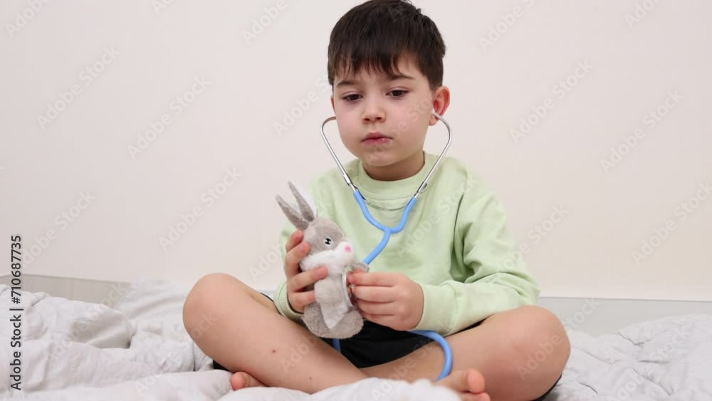 siblings boys brothers playing with stethoscope in doctor pediatrician. smiling happy kid with ear tips in ears.child using bell, chest piece to listen the breathing.baby with soft toy as patient.4k siblings boys brothers playing with stethoscope in doctor pediatrician. smiling happy kid with ear tips in ears.child using bell, chest piece to listen the breathing.baby with soft toy as patient.4k