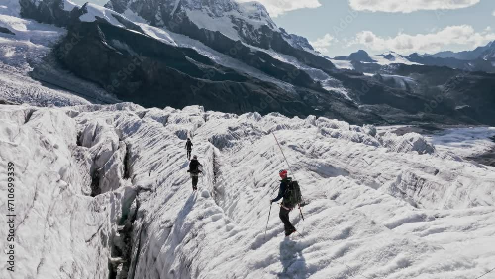 People climb the Monte Rosa glacier in Switzerland. Their bodies cast shadows on the ice People climb the Monte Rosa glacier in Switzerland. Their bodies cast shadows on the ice