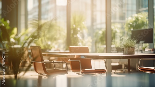 Blurred photo of sunny morning office with no people with green tropical plants photo