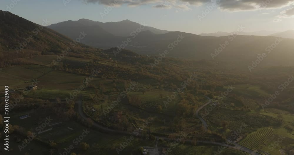 Aerial view of a mountains and hills landscape with vineyard and countryside houses at sunset in autumn colours, Irpinia, Avellino, Campania, Italy. Aerial view of a mountains and hills landscape with vineyard and countryside houses at sunset in autumn colours, Irpinia, Avellino, Campania, Italy.