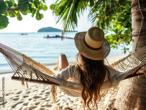 Traveler woman relax in hammock on summer beach Thailand, sunny summer day, tropical flowers around