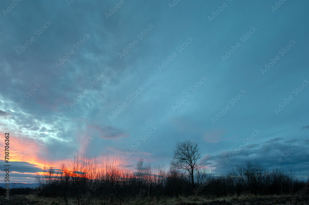 Summer sunset over wheat field. Beautiful sunset sky over countryside