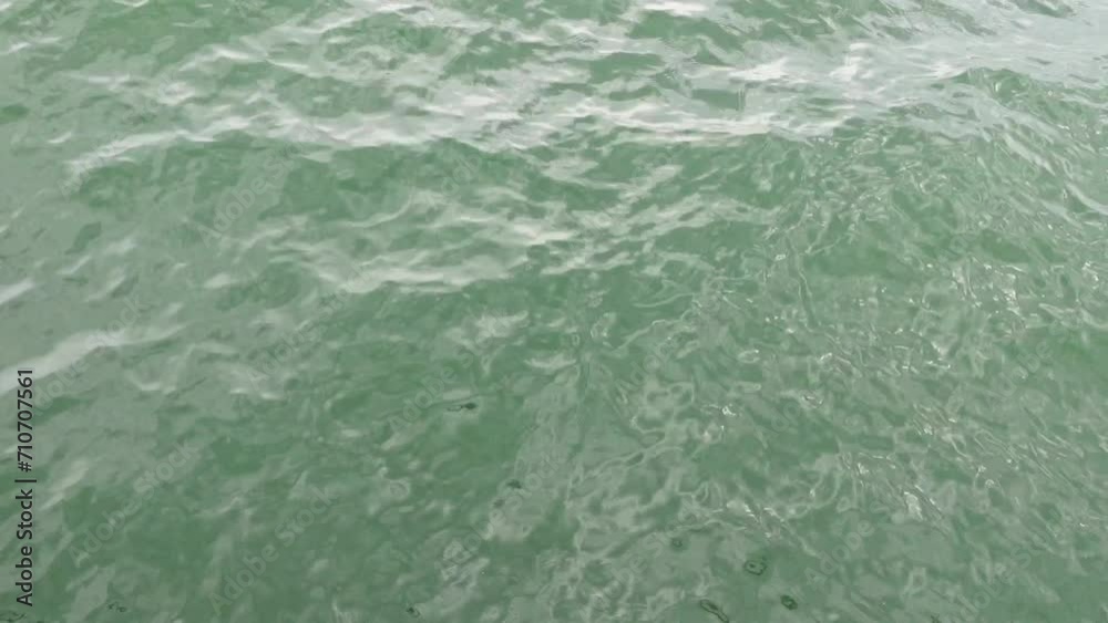 Sunlight and its reflection on small ripples of green river water. Greenish crystal river water background. Sunlight and its reflection on small ripples of green river water. Greenish crystal river water background.