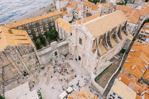 People walk around the square in front of the Church of St. Ignatius. Dubrovnik, Croatia. Drone photo