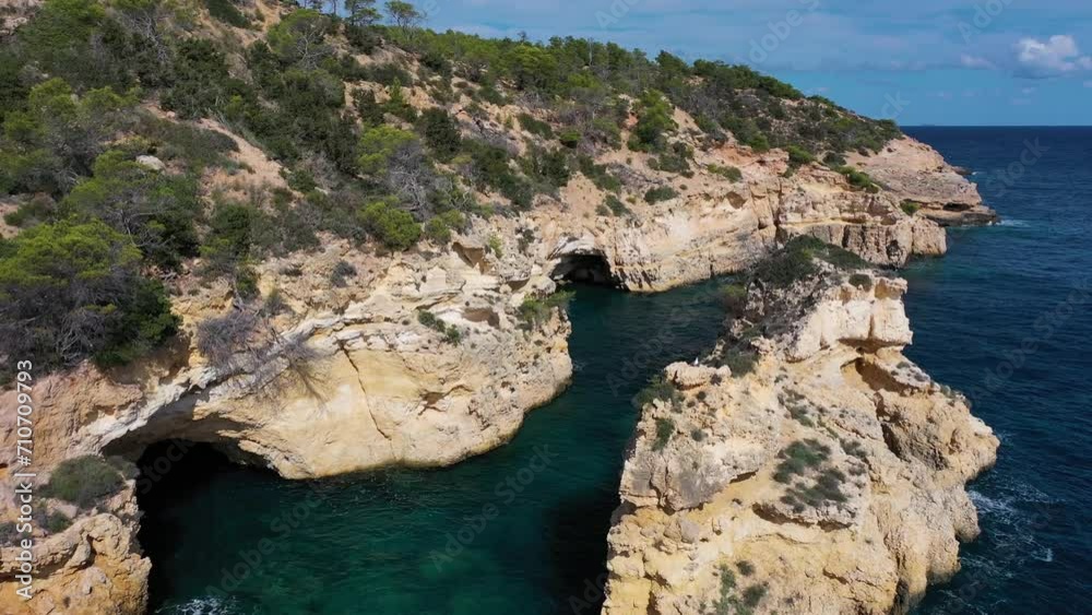 Aerial view of the Mediterranean Sea coastline with high cliffs and coves, Punta de Llevant, Ibiza, Balearic Islands, Spain. Aerial view of the Mediterranean Sea coastline with high cliffs and coves, Punta de Llevant, Ibiza, Balearic Islands, Spain.