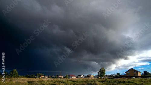 Amazing dark stormy tornado clouds over the city.