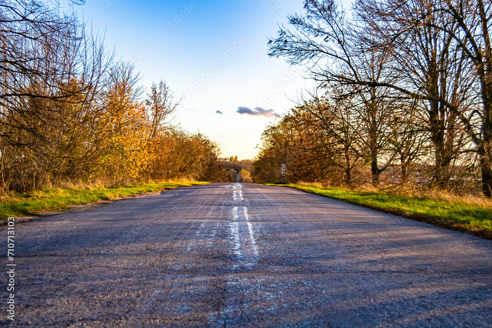 Fototapeta premium Beautiful empty asphalt road in countryside on colored background